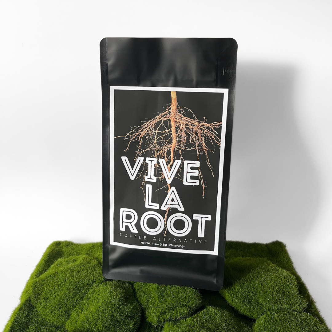 Black coffee packaging labeled 'Vive La Root' on a green textured surface with a white background