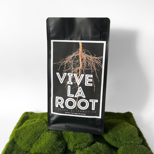 Black coffee packaging labeled 'Vive La Root' on a green textured surface with a white background