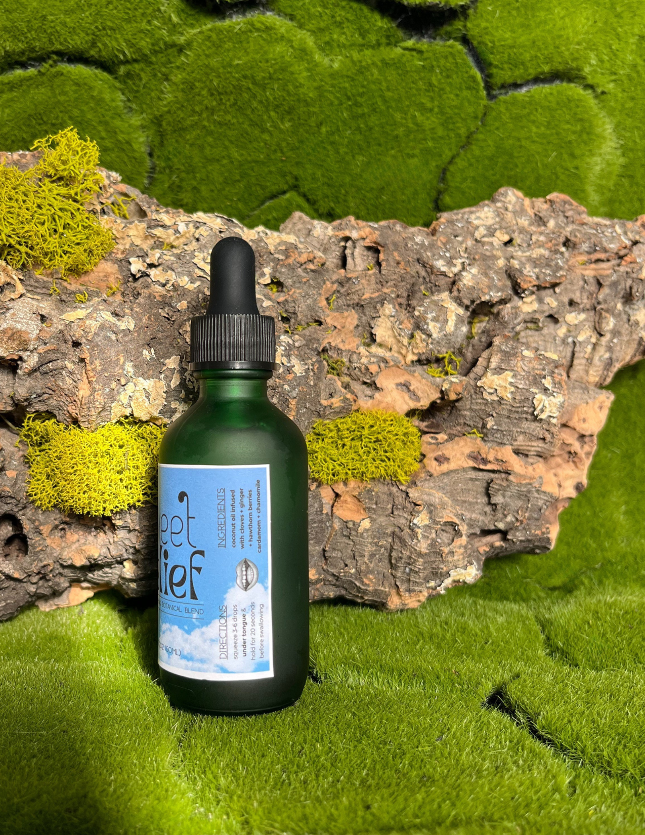 Bottle of 'sweet relief' on a natural background with greenery