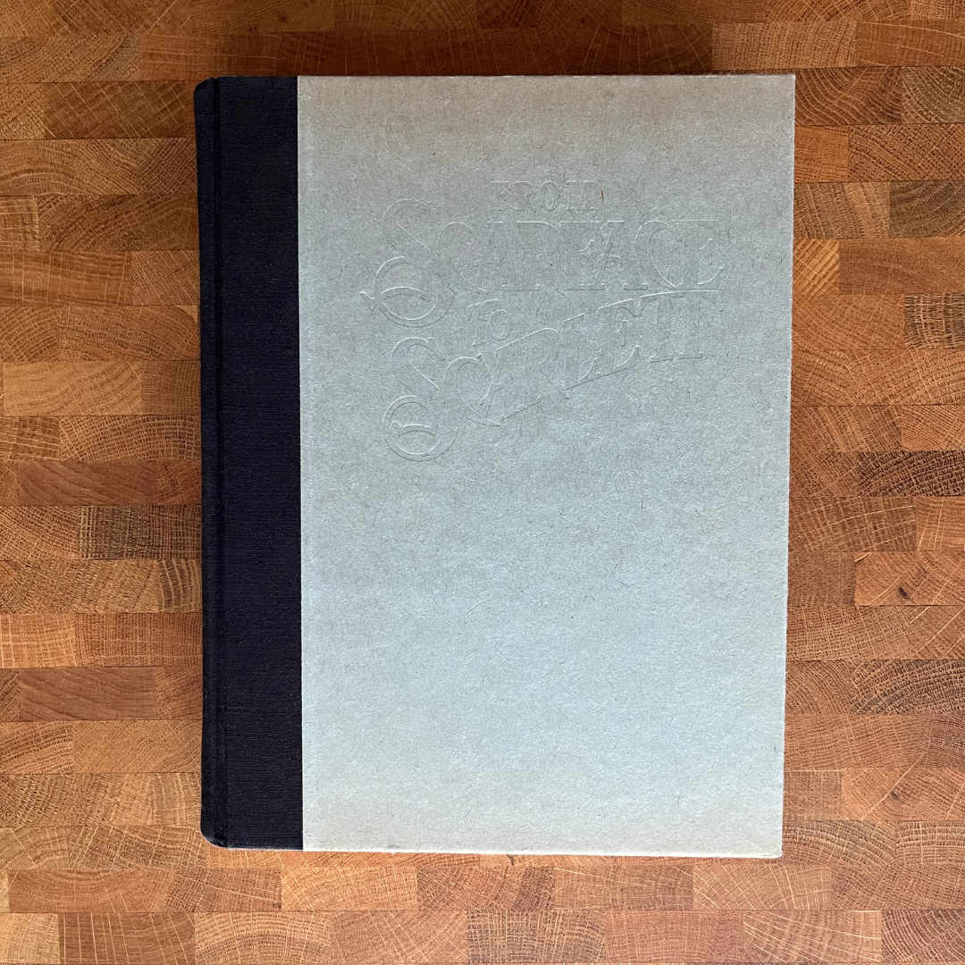 Gray book with black spine on a wooden surface