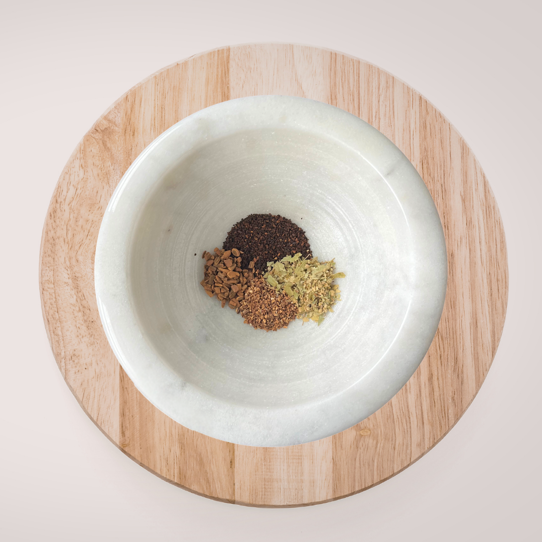 White bowl with spices on a wooden coaster