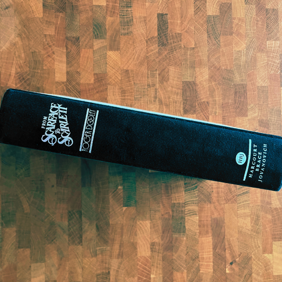 Black book with visible branding on a wooden surface
