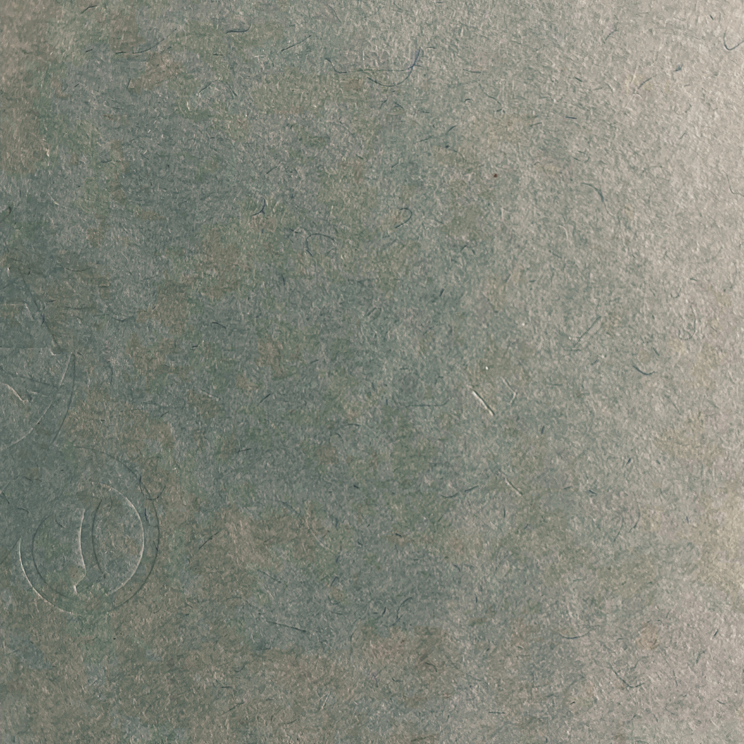 Close-up of a textured green surface with a logo.