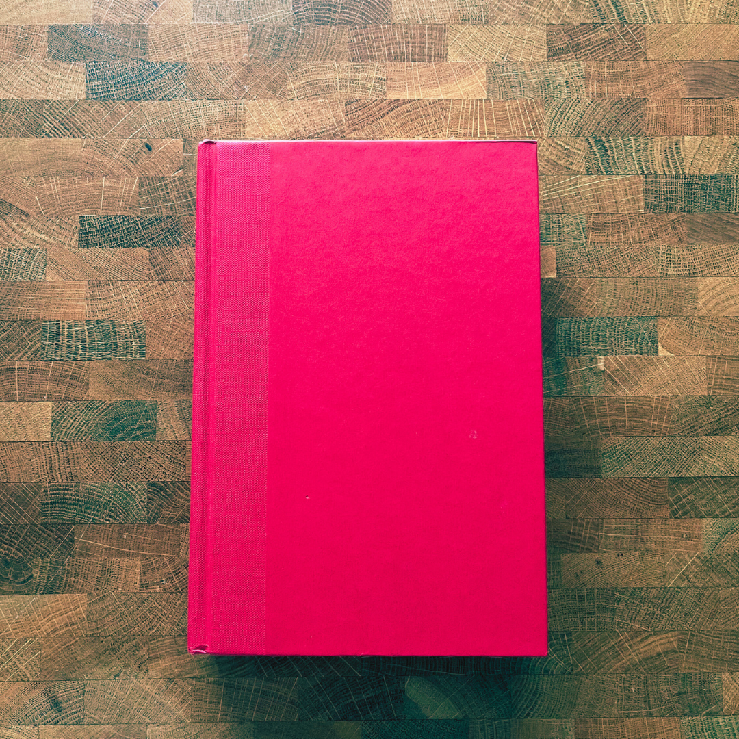 Pink book on a wooden surface