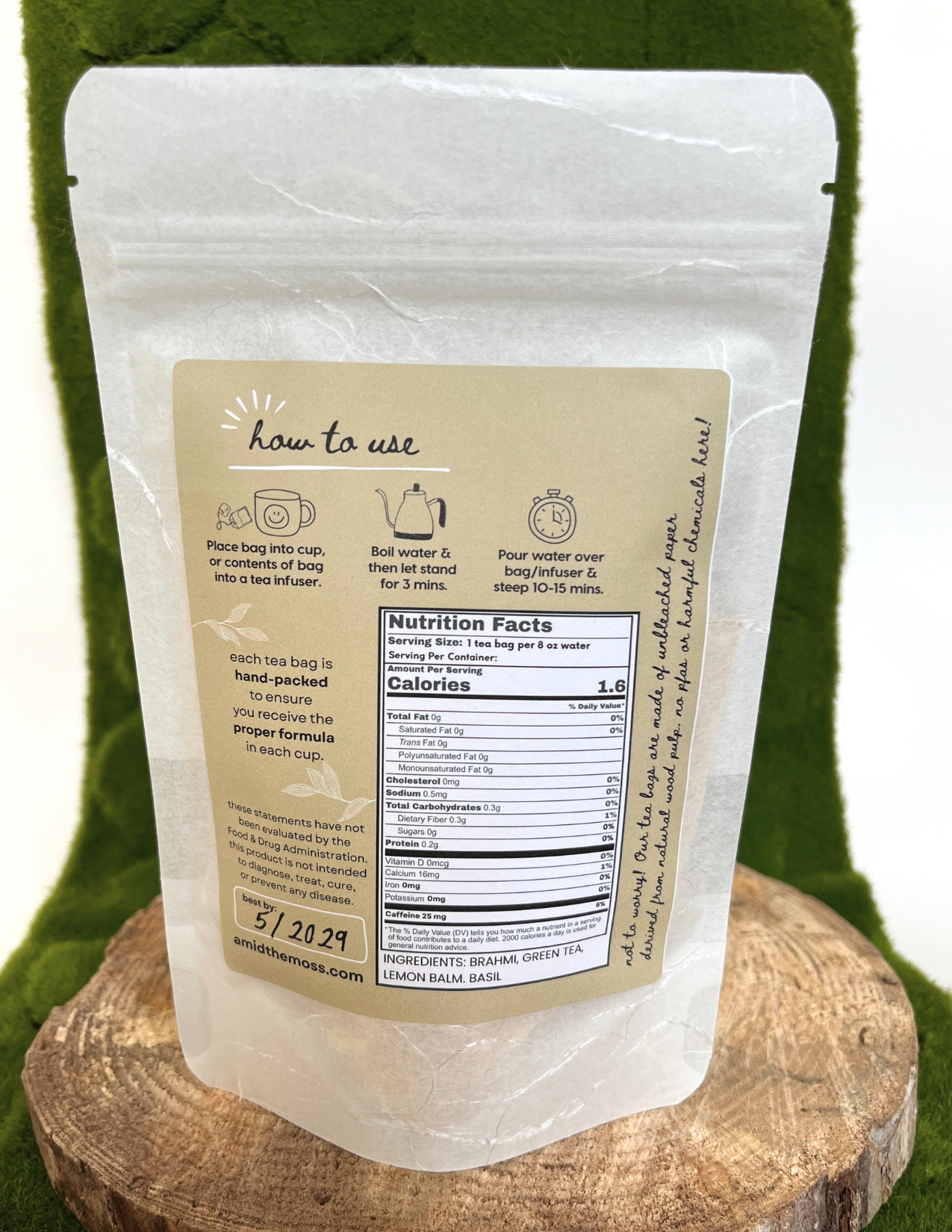 White product packaging with a label on a wooden block against a green background