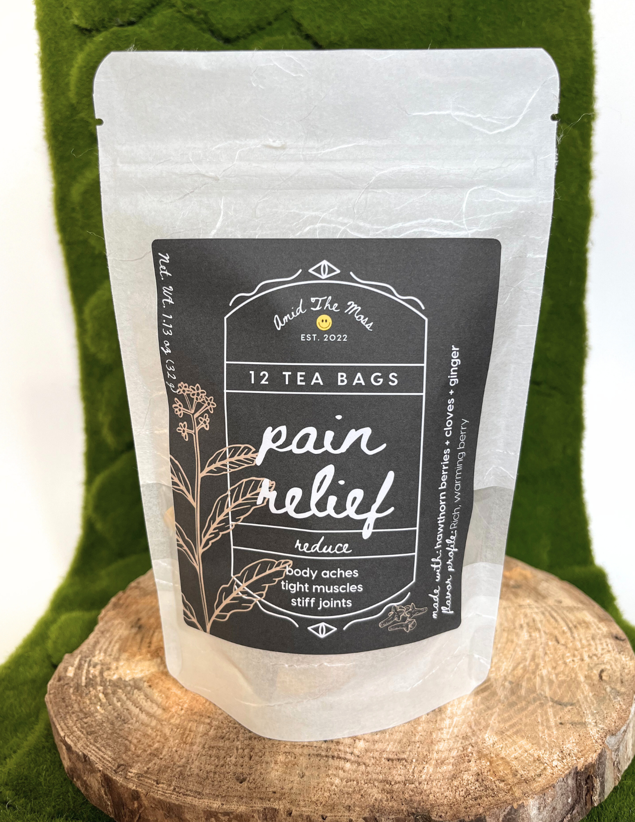 Tea bags labeled 'Pain Relief' on a wooden surface with a green textured background