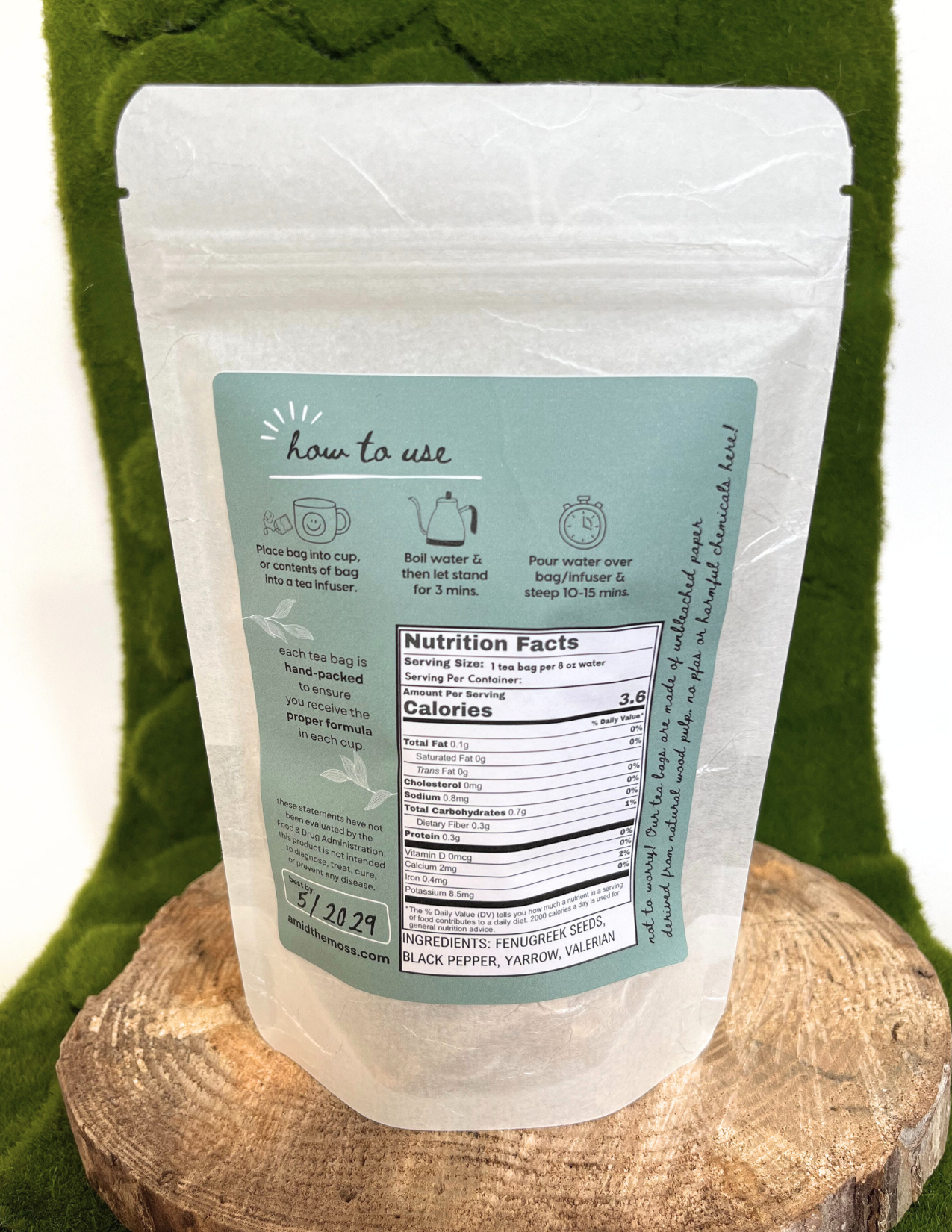 Clear packaging with green label on a wooden block against a green background