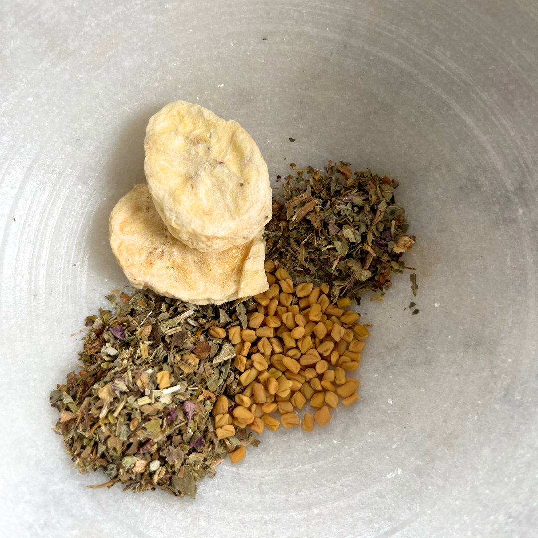 dried bananas, fenugreek seeds, basil, and gotu kola in a white marble bowl